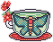 a teacup with a teal and red moth and red flowers on it