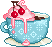 a blue teacup with whipped cream and cherries on top