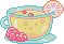 a glass teacup filled with sparkling lemonade, with a fruit slice garnish
